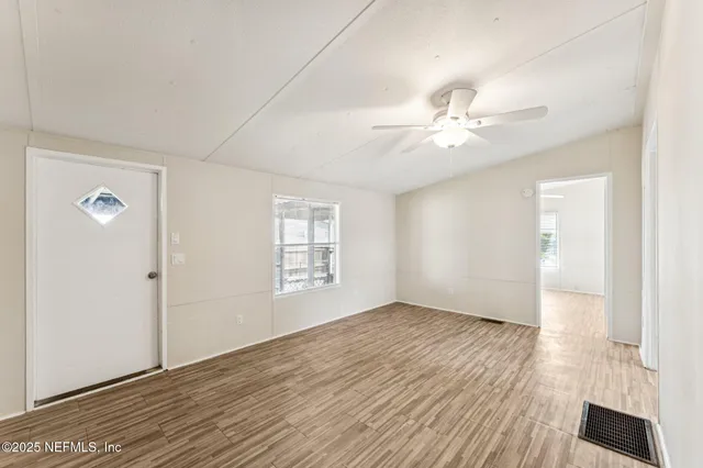 wooden floor in an empty room with a window