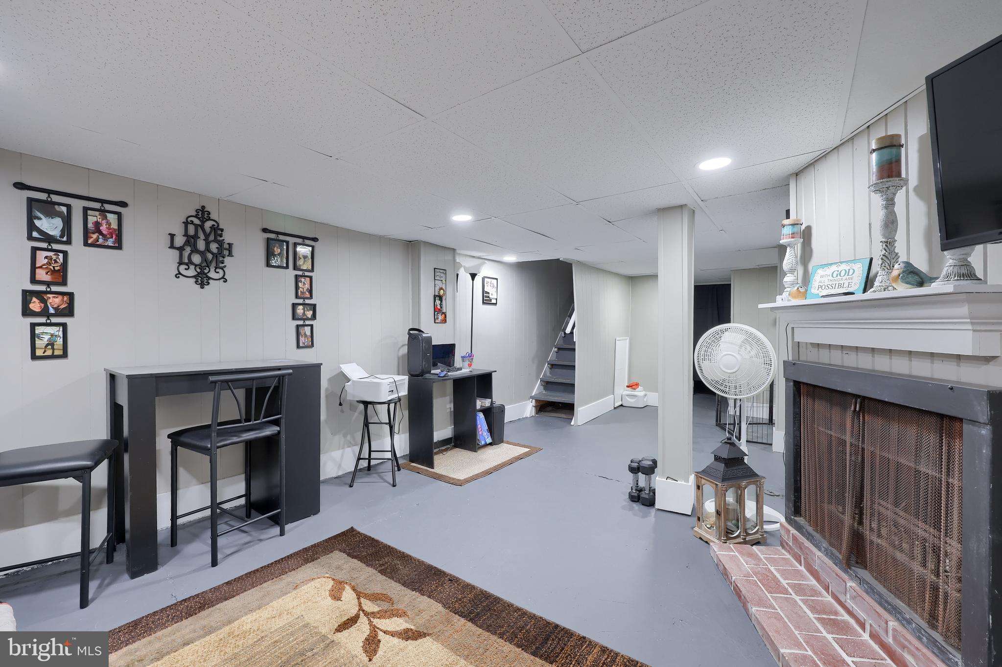 857 East Princess Street York, PA 17403 - Photo 28 of 38 a living room with furniture a fireplace and a flat screen tv