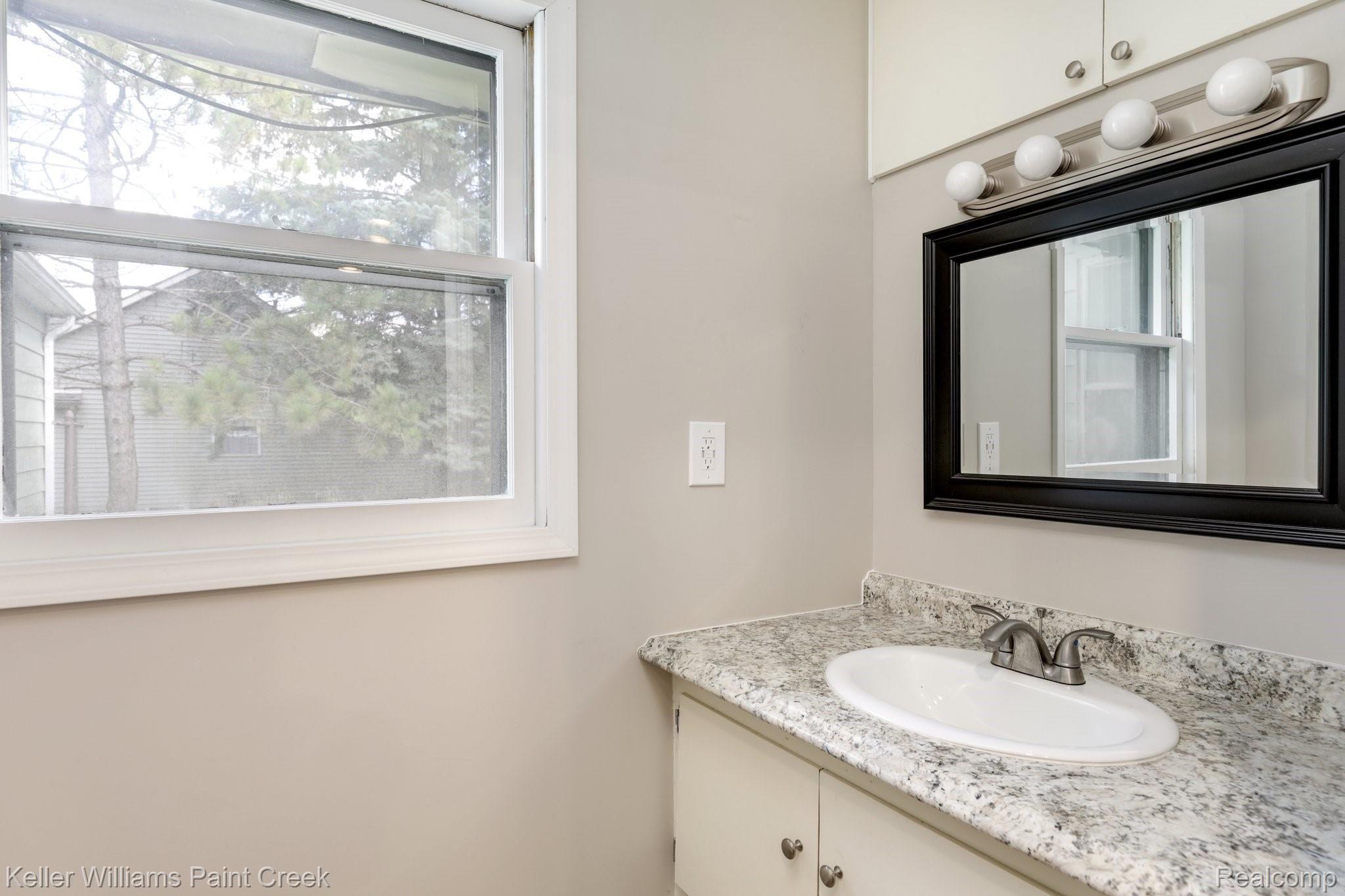 1146 East Gunn Road Rochester, MI 48306 - Photo 16 of 20 Half bath has been remodeled last year and offers a large vanity.