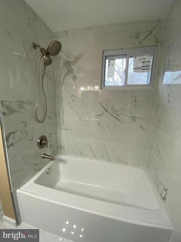 a bathroom with a bath tub with a shower