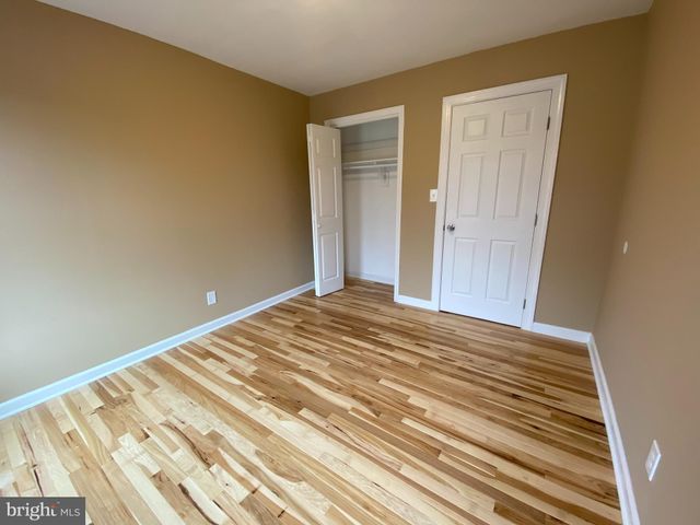a view of a room with wooden floor and closet