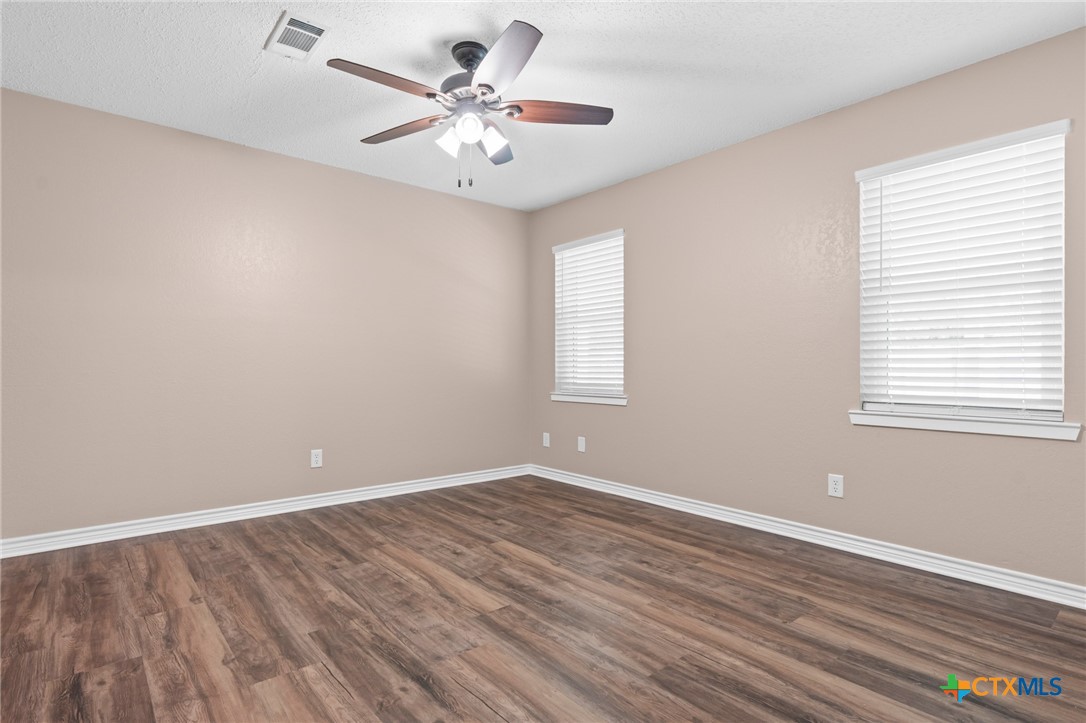 607 South Nancy Ann Street Hamilton, TX 76531 - Photo 14 of 26 wooden floor in an empty room with a window
