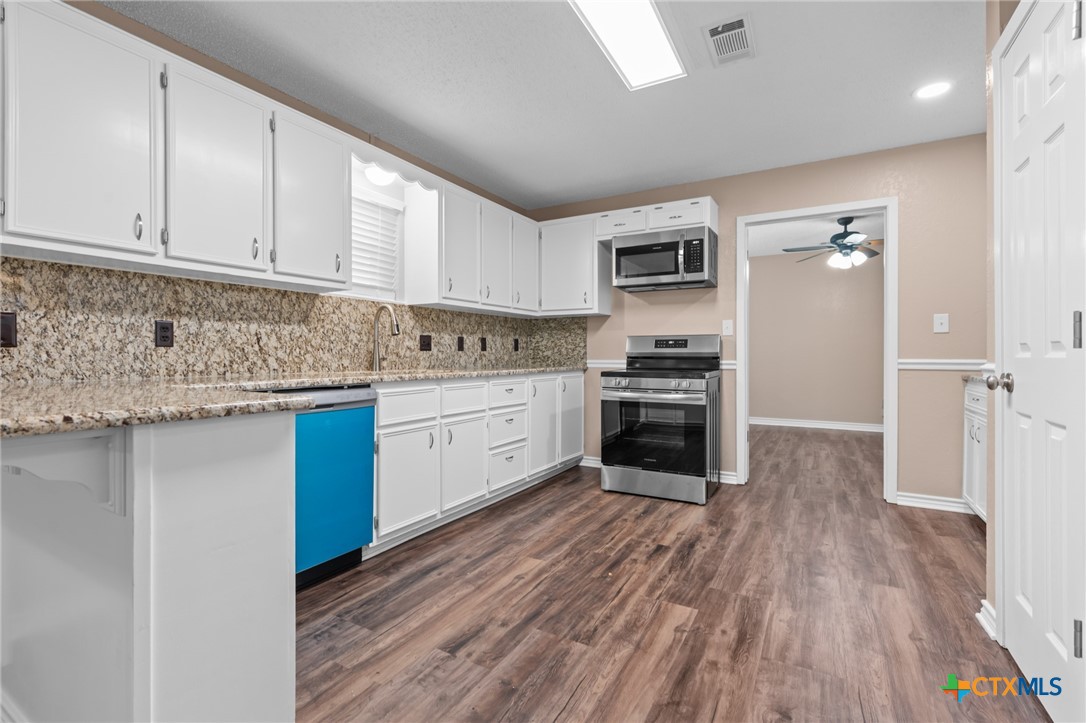 607 South Nancy Ann Street Hamilton, TX 76531 - Photo 8 of 26 a kitchen with stainless steel appliances granite countertop a stove sink and cabinets