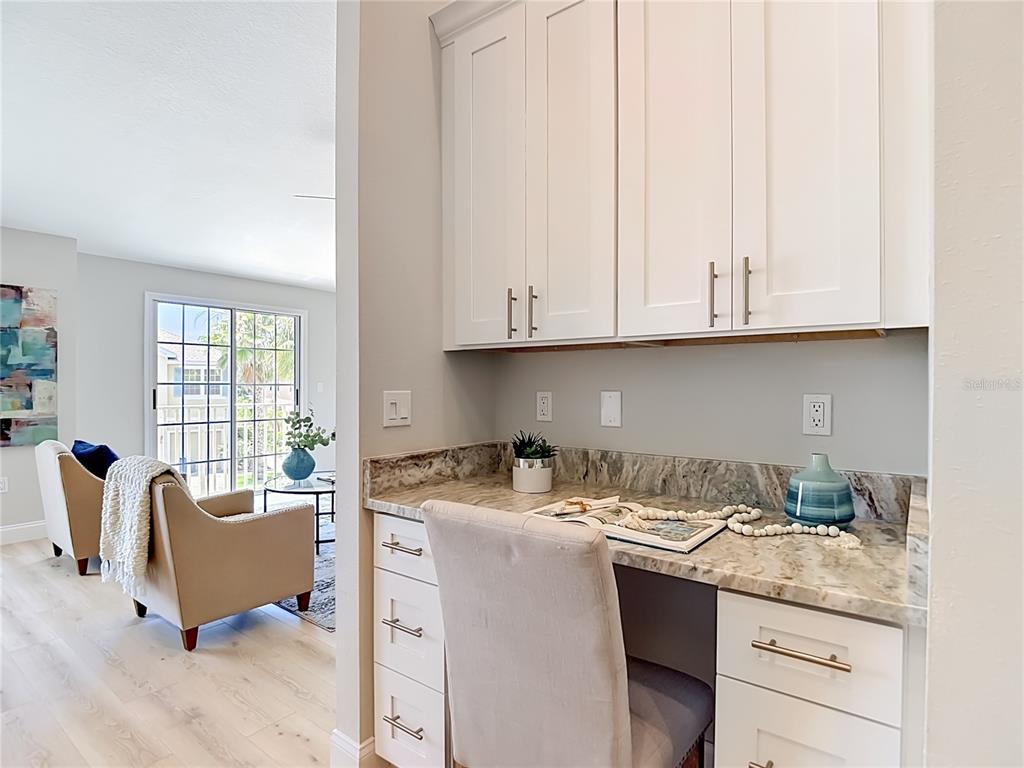 5310 Anhinga Trail New Port Richey, FL 34653 - Photo 10 of 27 a kitchen with stainless steel appliances granite countertop a sink stove and cabinets