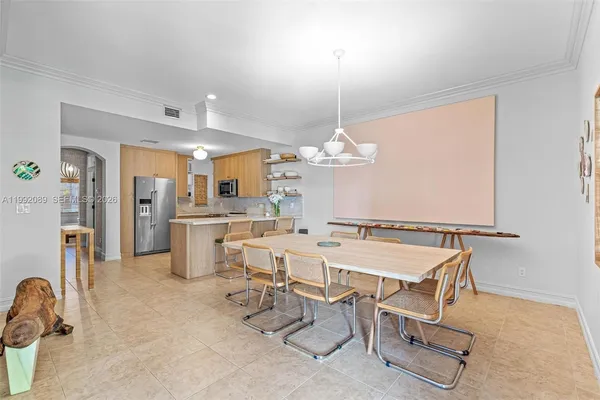 a view of a kitchen with refrigerator and white cabinets