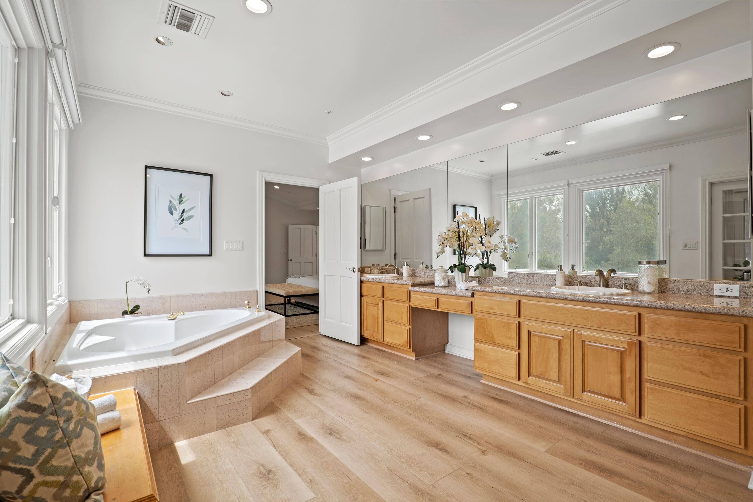 24335 Arcadia Street Newhall, CA 91321 - Photo 27 of 50 a large bathroom with a large tub sink and double vanity