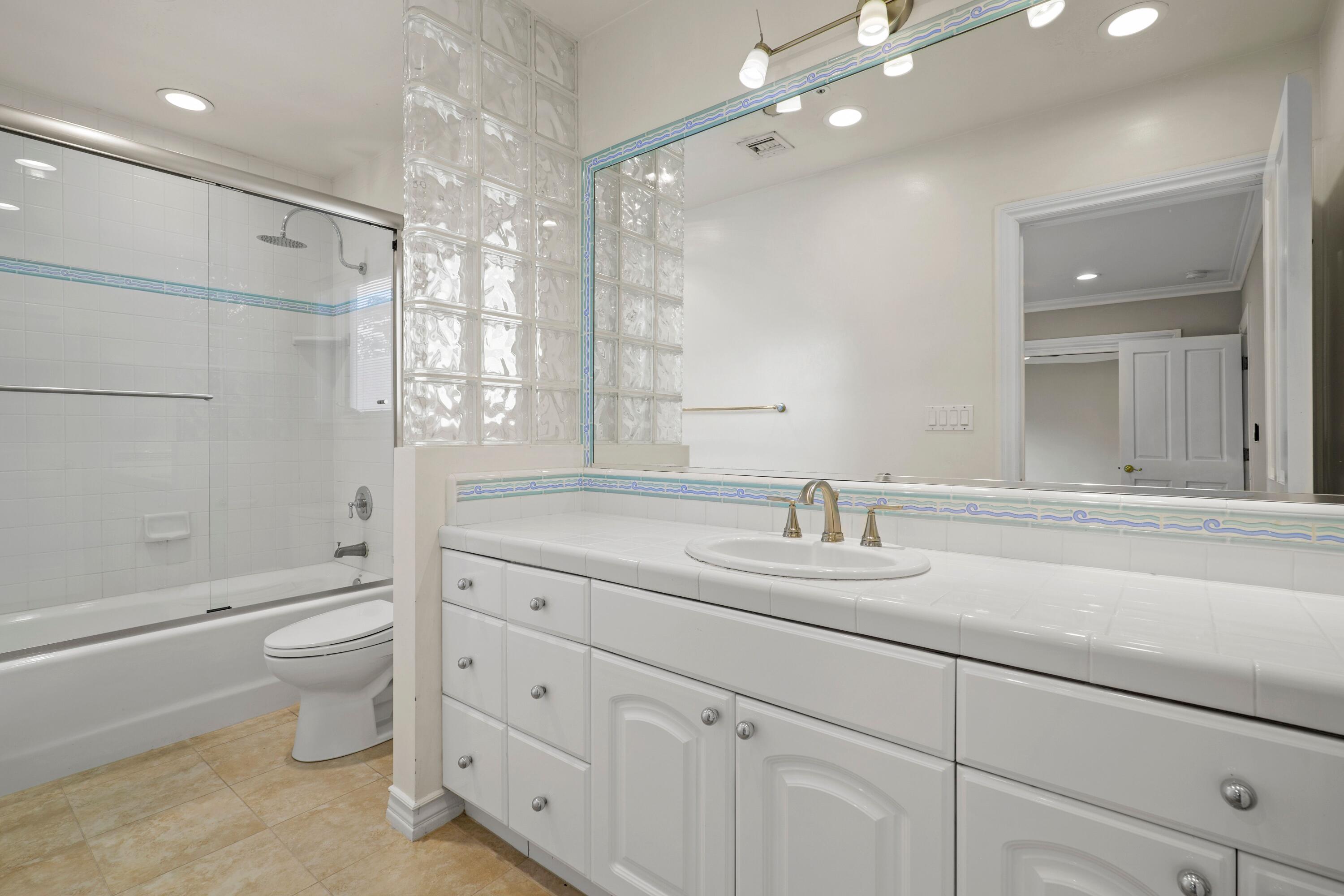 24335 Arcadia Street Newhall, CA 91321 - Photo 36 of 50 a bathroom with a double vanity sink toilet mirror and shower