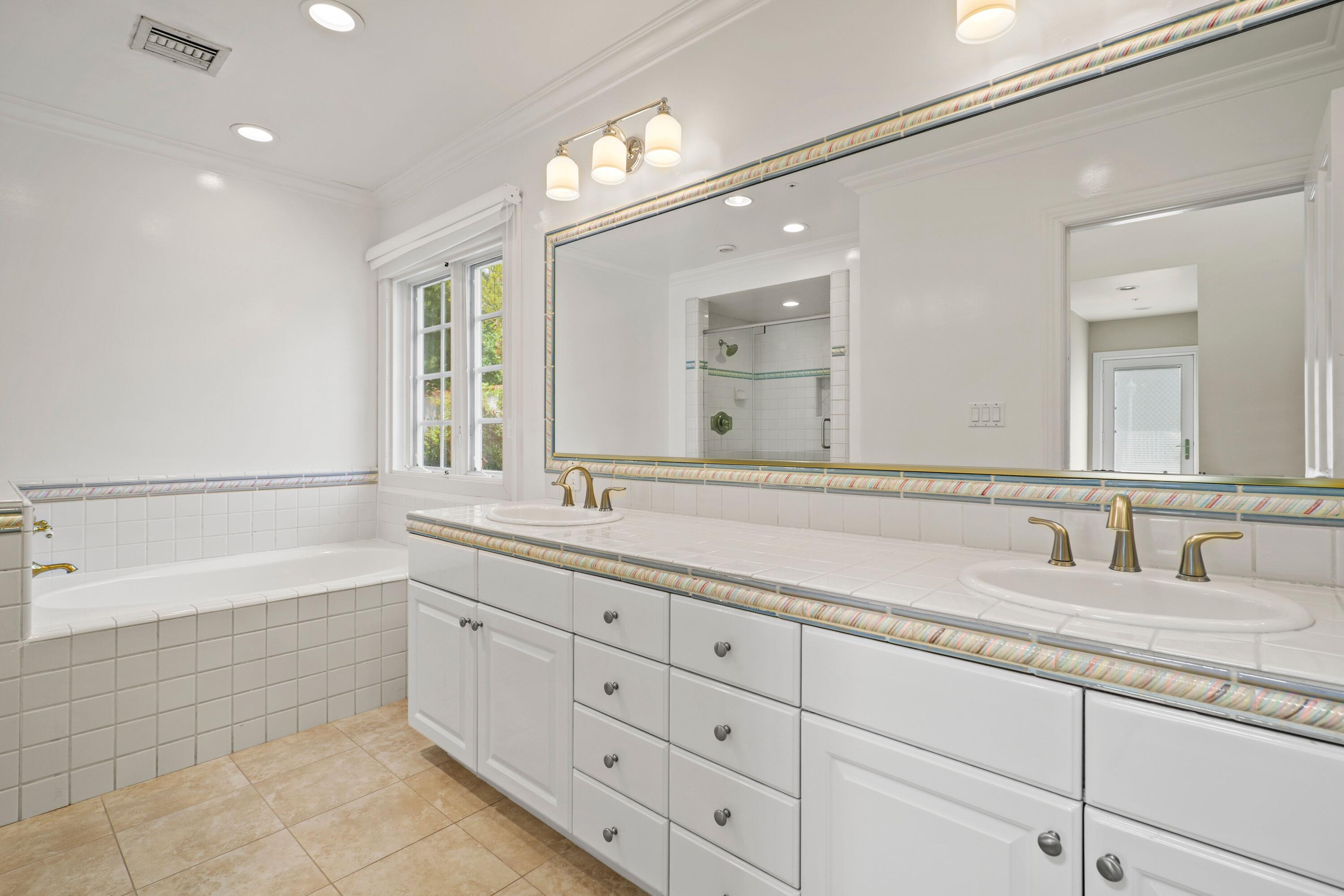 24335 Arcadia Street Newhall, CA 91321 - Photo 38 of 50 a bathroom with double sink and a mirror