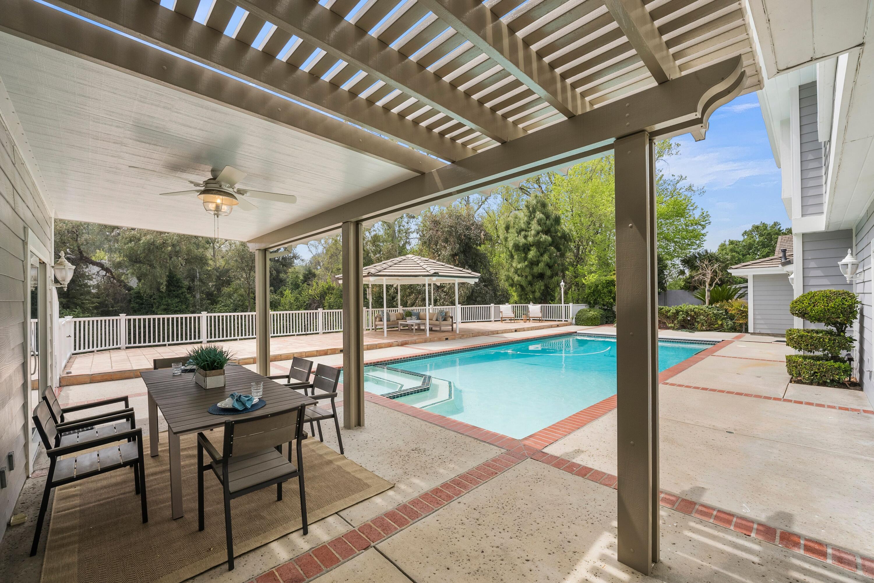 24335 Arcadia Street Newhall, CA 91321 - Photo 44 of 50 a view of a patio with a table chairs and a backyard
