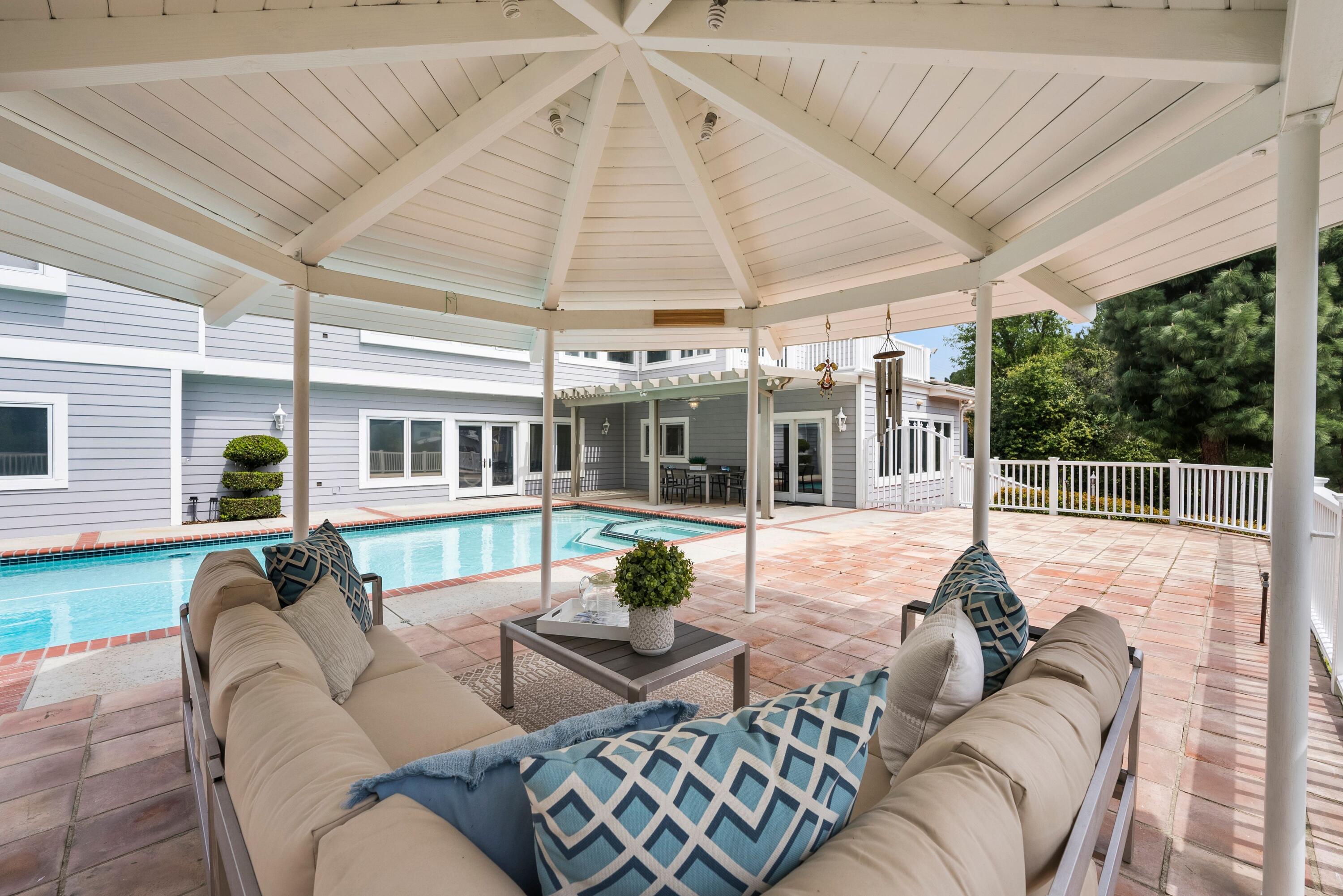 24335 Arcadia Street Newhall, CA 91321 - Photo 45 of 50 a view of a patio with couches chairs and potted plants