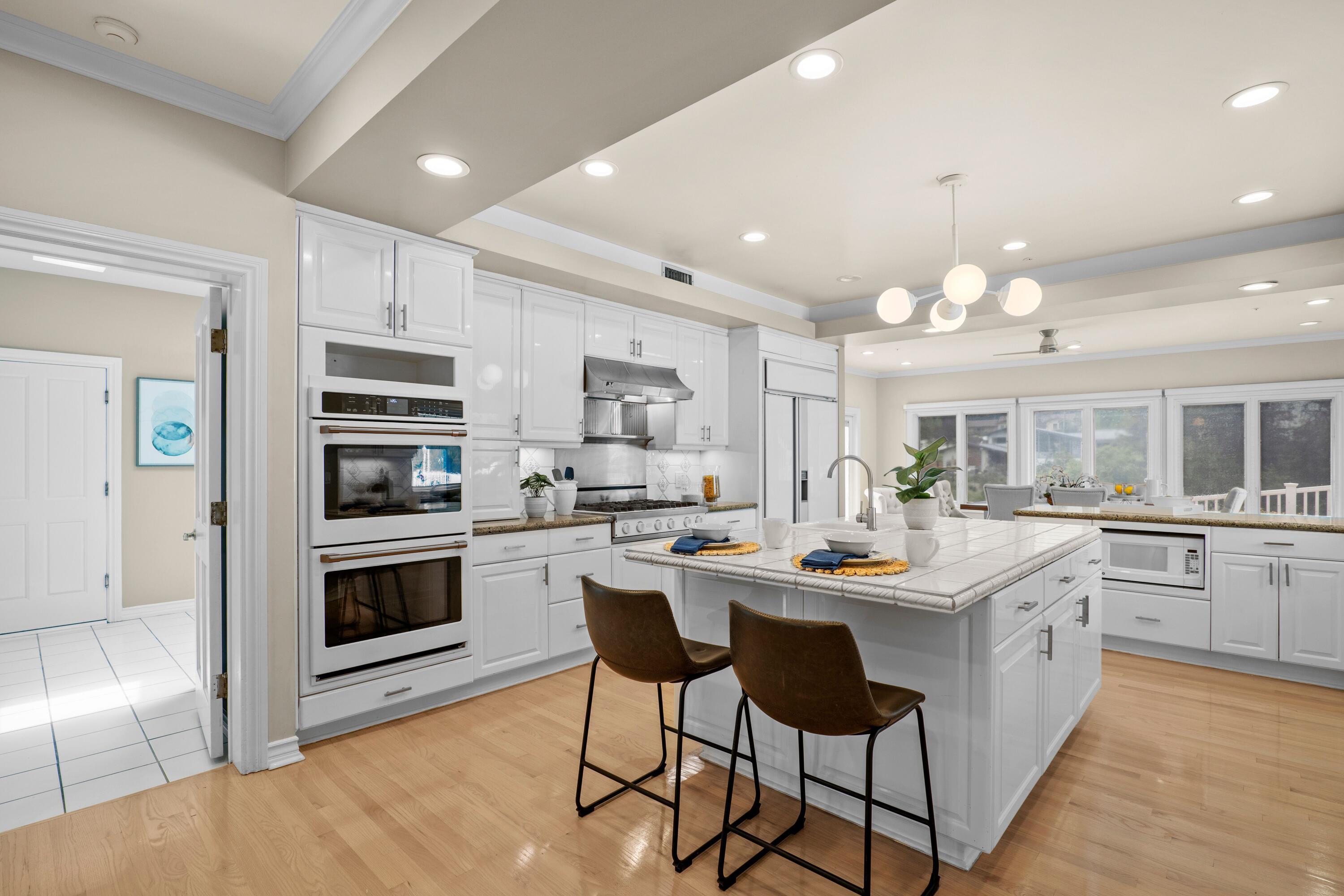 24335 Arcadia Street Newhall, CA 91321 - Photo 6 of 50 a kitchen with stainless steel appliances kitchen island granite countertop a sink and cabinets