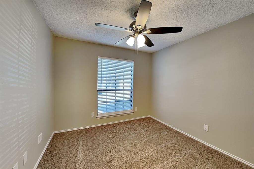 1602 Spring Street Allen, TX 75002 - Photo 12 of 20 an empty room with windows and fan