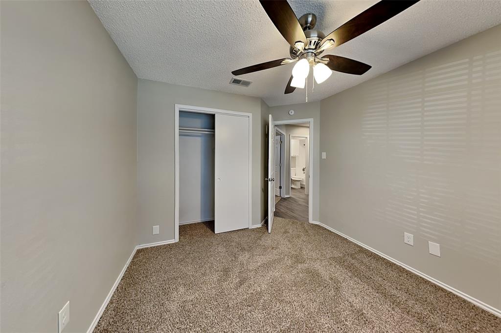 1602 Spring Street Allen, TX 75002 - Photo 13 of 20 an empty room with closet and a ceiling fan