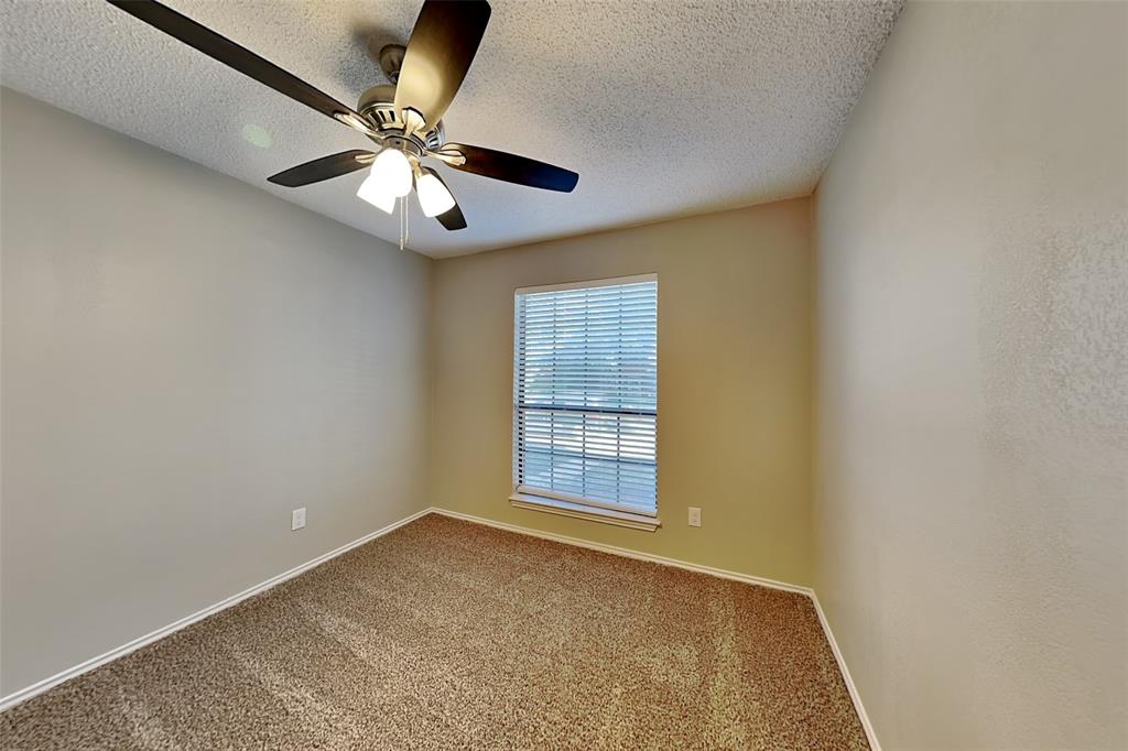 1602 Spring Street Allen, TX 75002 - Photo 15 of 20 an empty room with a ceiling fan and window