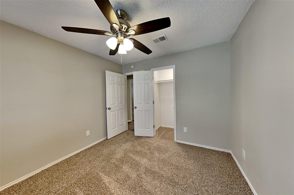 1602 Spring Street Allen, TX 75002 - Photo 16 of 20 an empty room with closet and fan