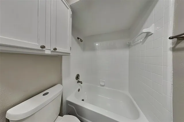 a bathroom with a toilet and bathtub