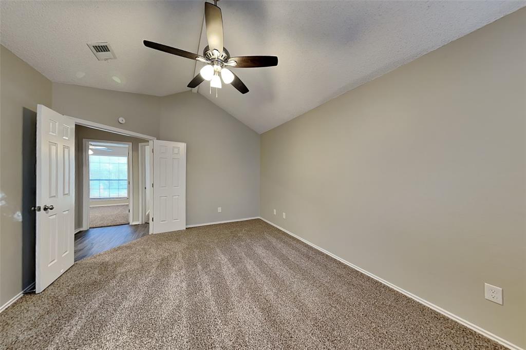 1602 Spring Street Allen, TX 75002 - Photo 8 of 20 an empty room with chandelier fan and windows
