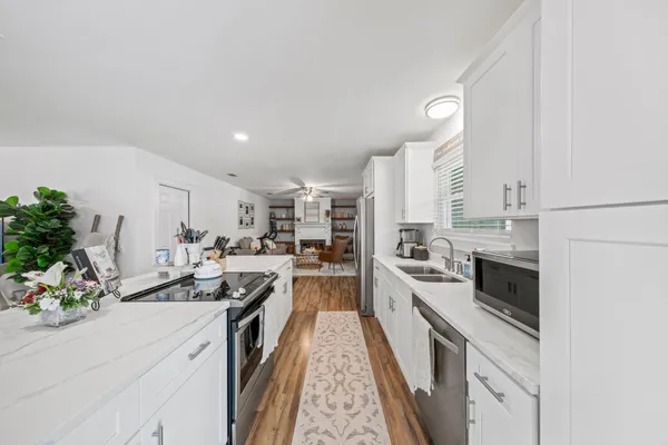 a kitchen with a sink stove and cabinets