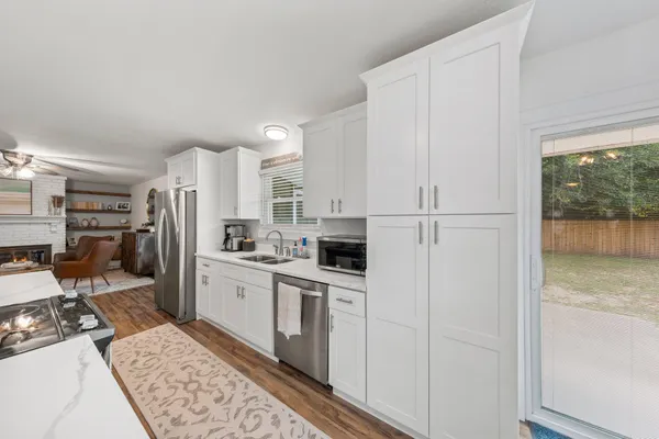 a kitchen with stainless steel appliances granite countertop a refrigerator sink and stove
