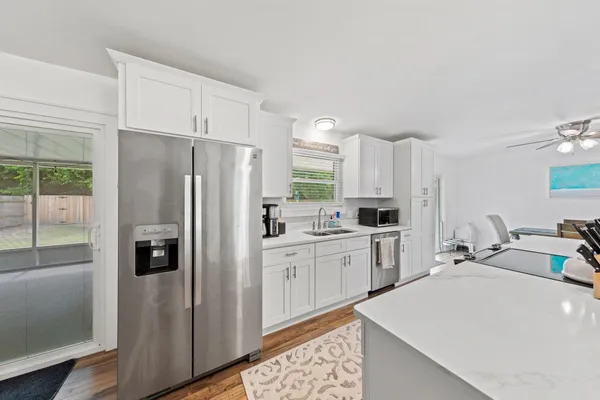 a kitchen with a refrigerator a sink and cabinets