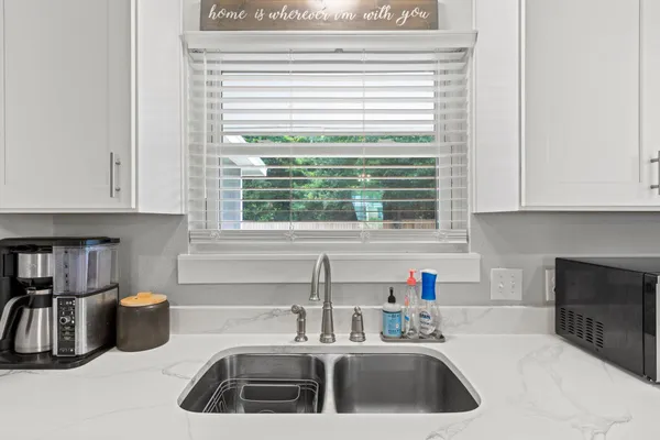 a kitchen with a sink cabinets and a window