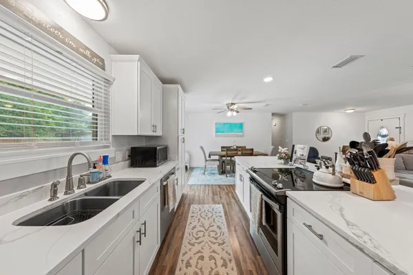 a kitchen with a sink stove and cabinets