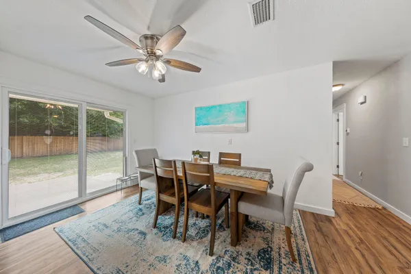 a view of a dining room with furniture wooden floor and fan