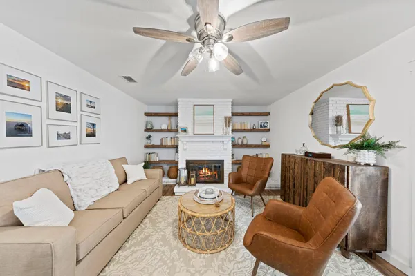 a living room with furniture a fireplace and a chandelier