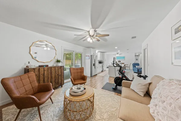 a living room with furniture a clock and a chandelier