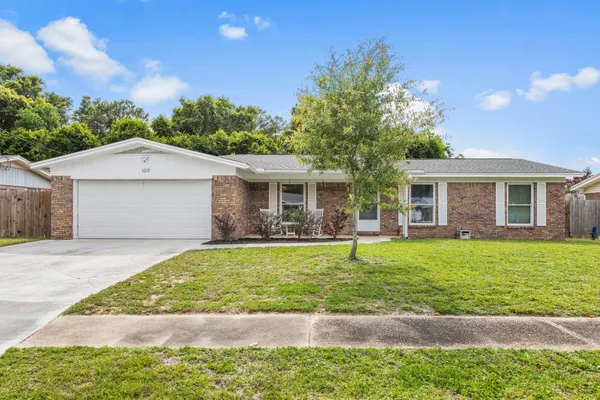 a front view of a house with a yard and porch