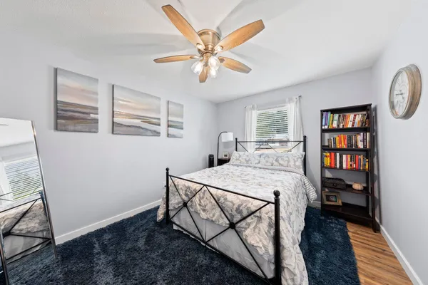 a bed room with a bed and a bookshelf