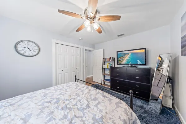 a bedroom with a bed and a chandelier