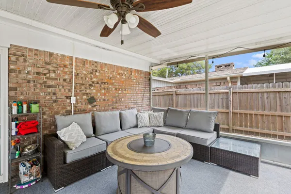 a living room with furniture and a floor to ceiling window