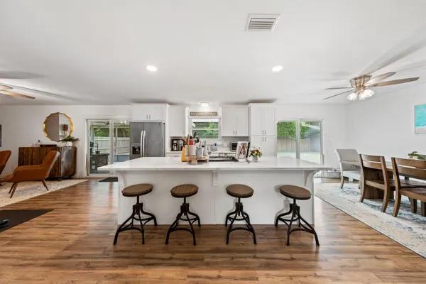 a kitchen with sink and chairs