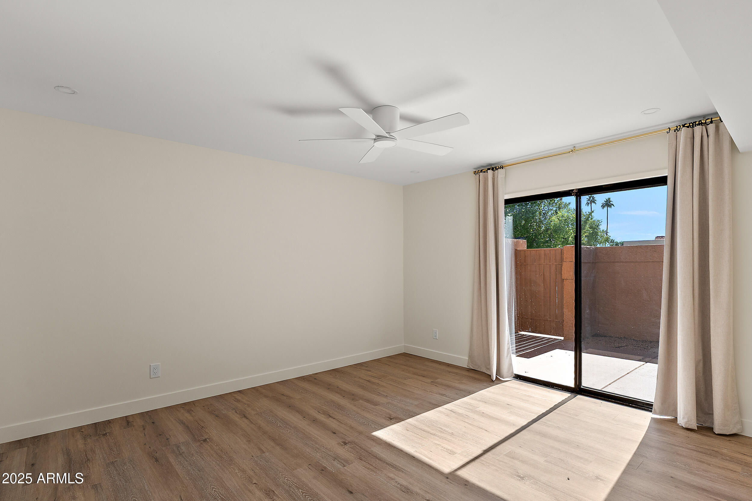 1319 East Susan Lane Tempe, AZ 85288 - Photo 11 of 23 an empty room with wooden floor and windows