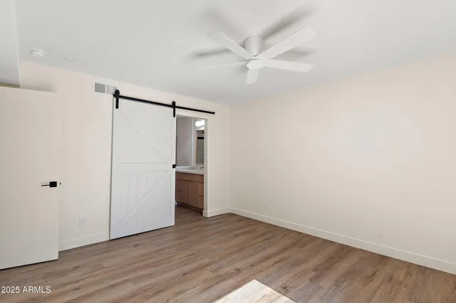a view of empty room with wooden floor