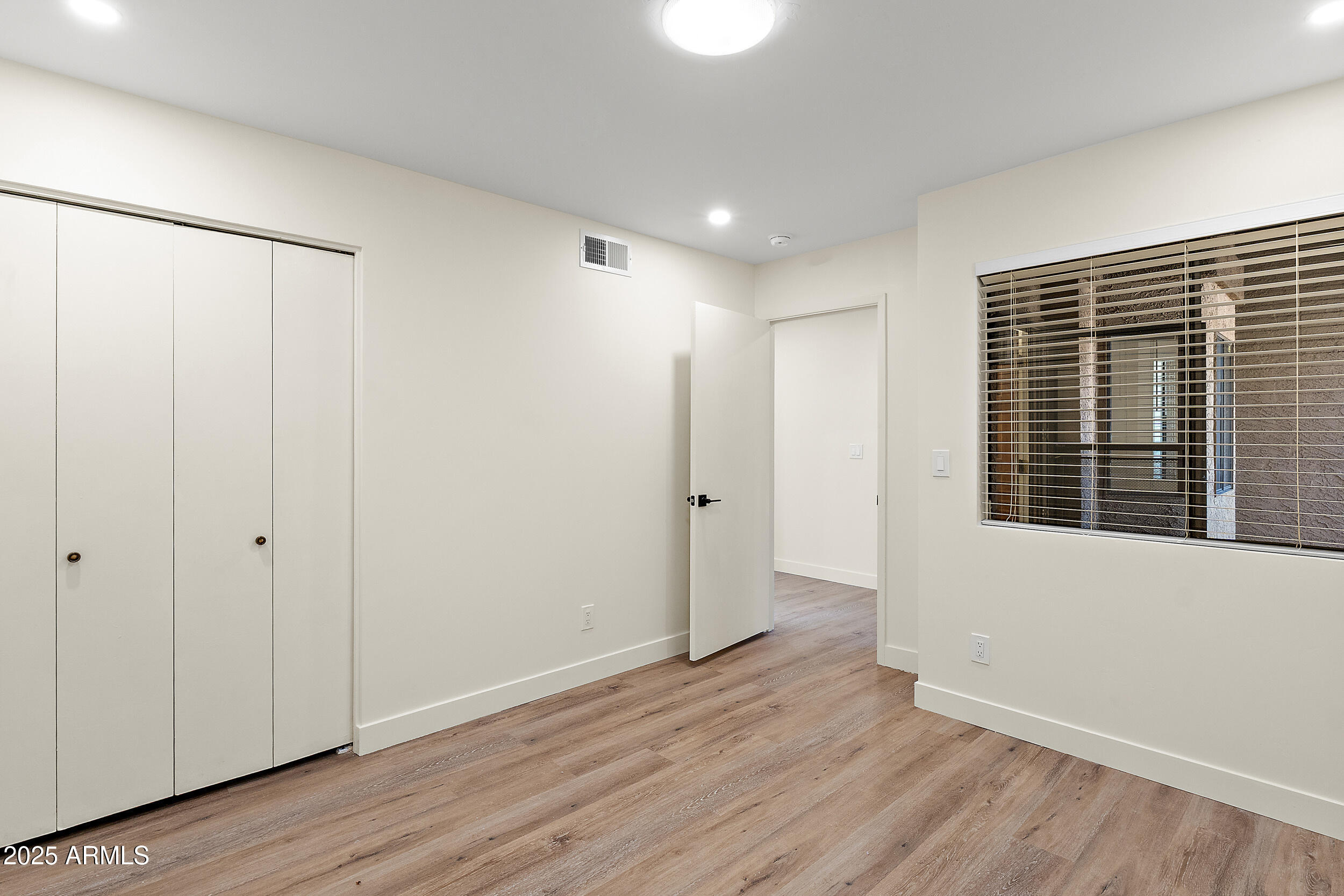 1319 East Susan Lane Tempe, AZ 85288 - Photo 18 of 23 a view of an empty room with wooden floor and a window