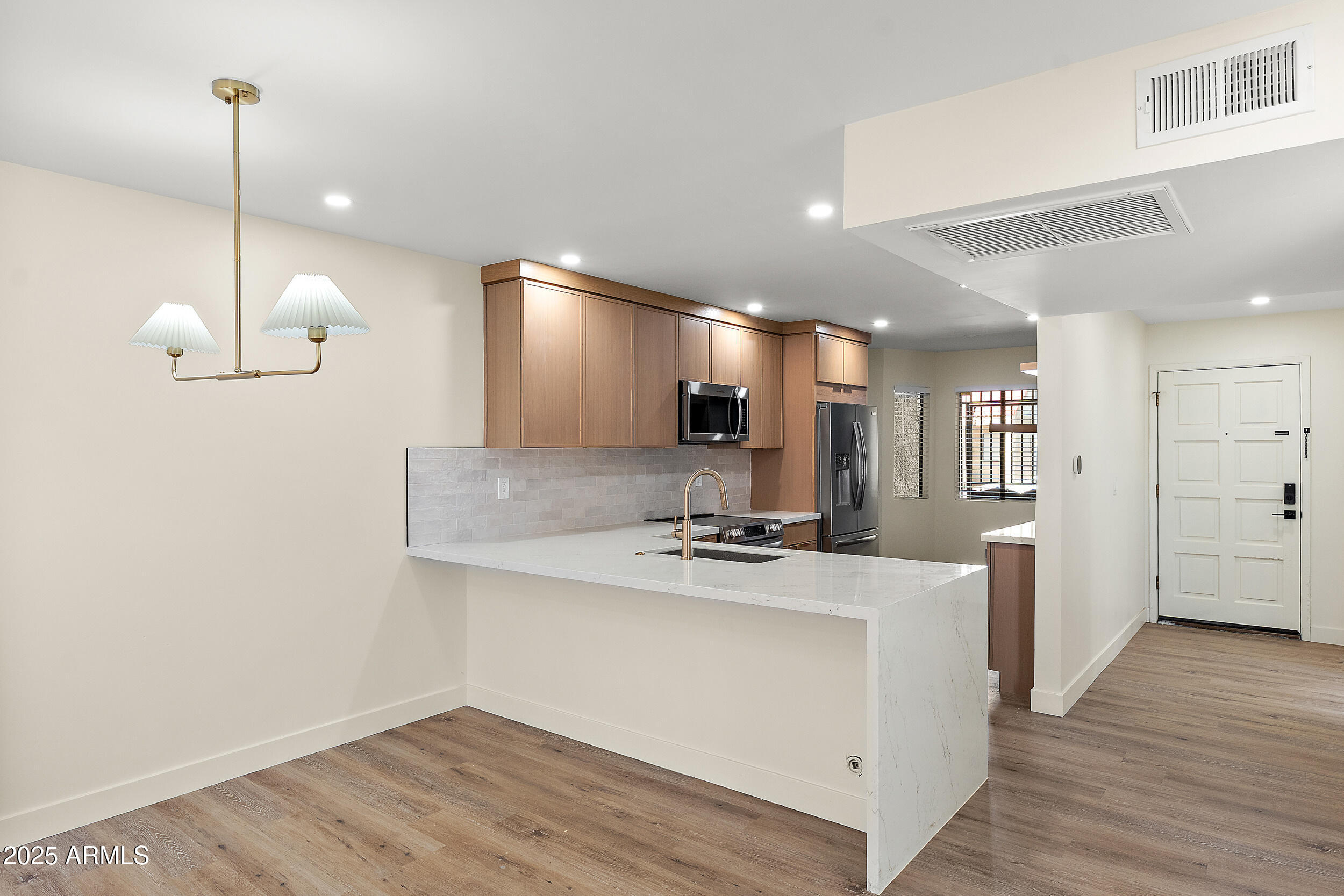 1319 East Susan Lane Tempe, AZ 85288 - Photo 3 of 23 a view of a kitchen with a sink and refrigerator
