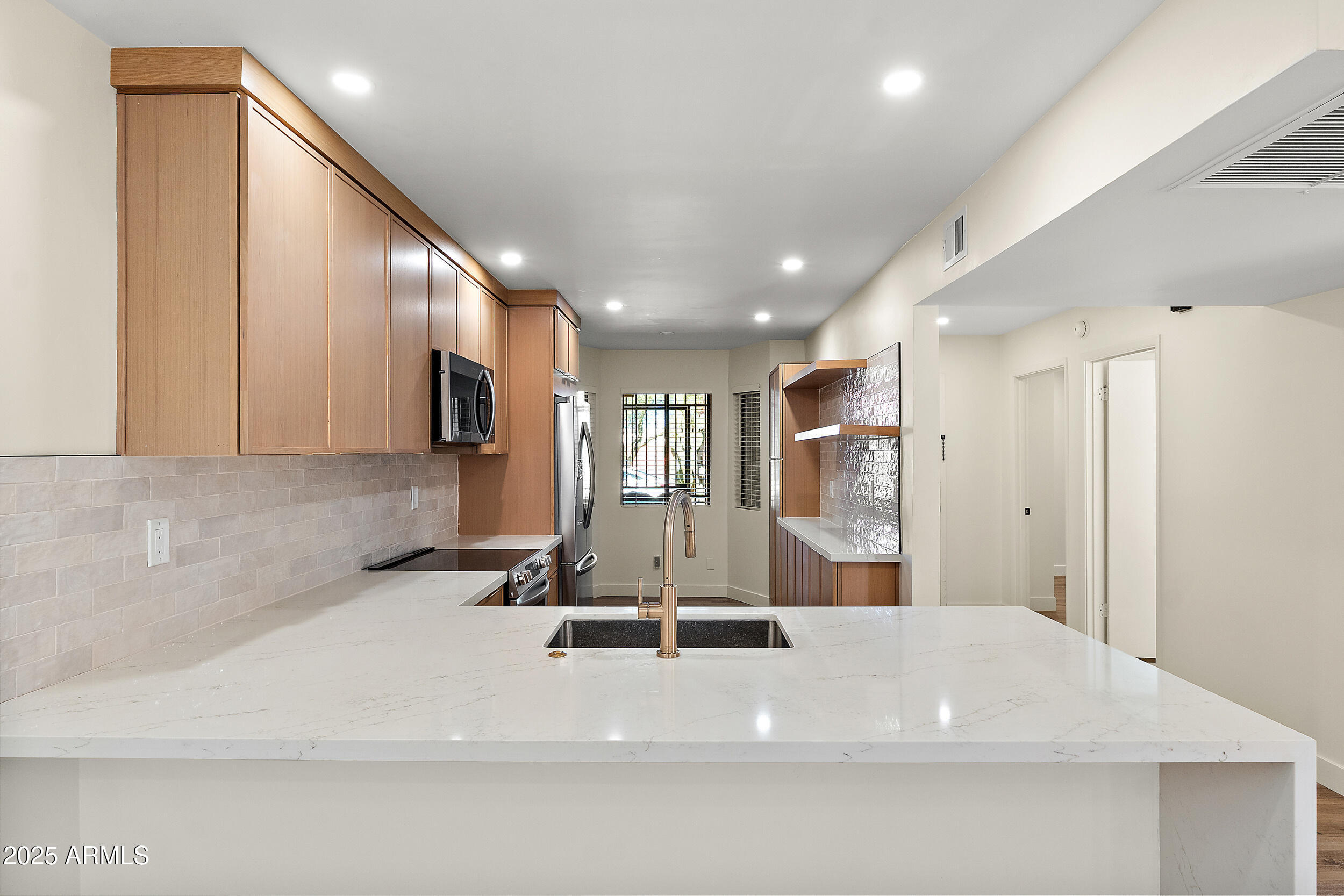 1319 East Susan Lane Tempe, AZ 85288 - Photo 4 of 23 a view of a kitchen with a sink and a refrigerator