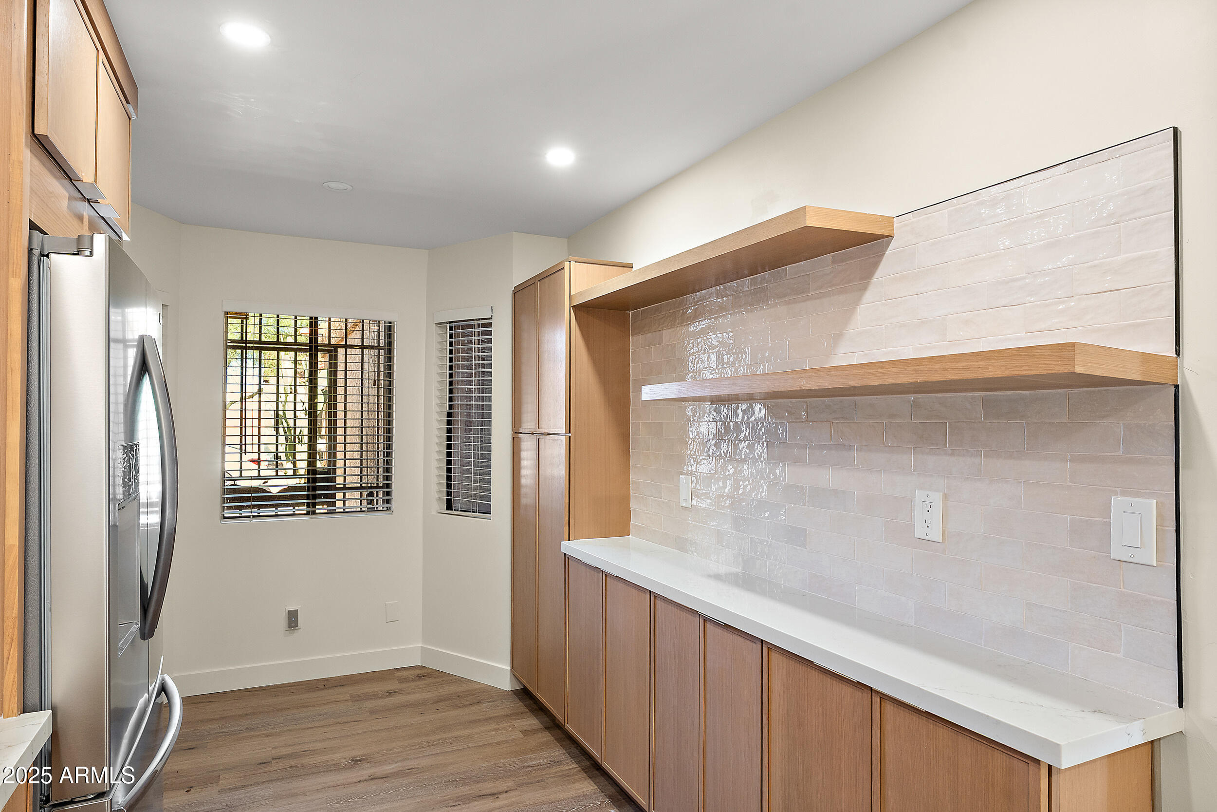 1319 East Susan Lane Tempe, AZ 85288 - Photo 5 of 23 a view of an empty room with wooden floor and a window