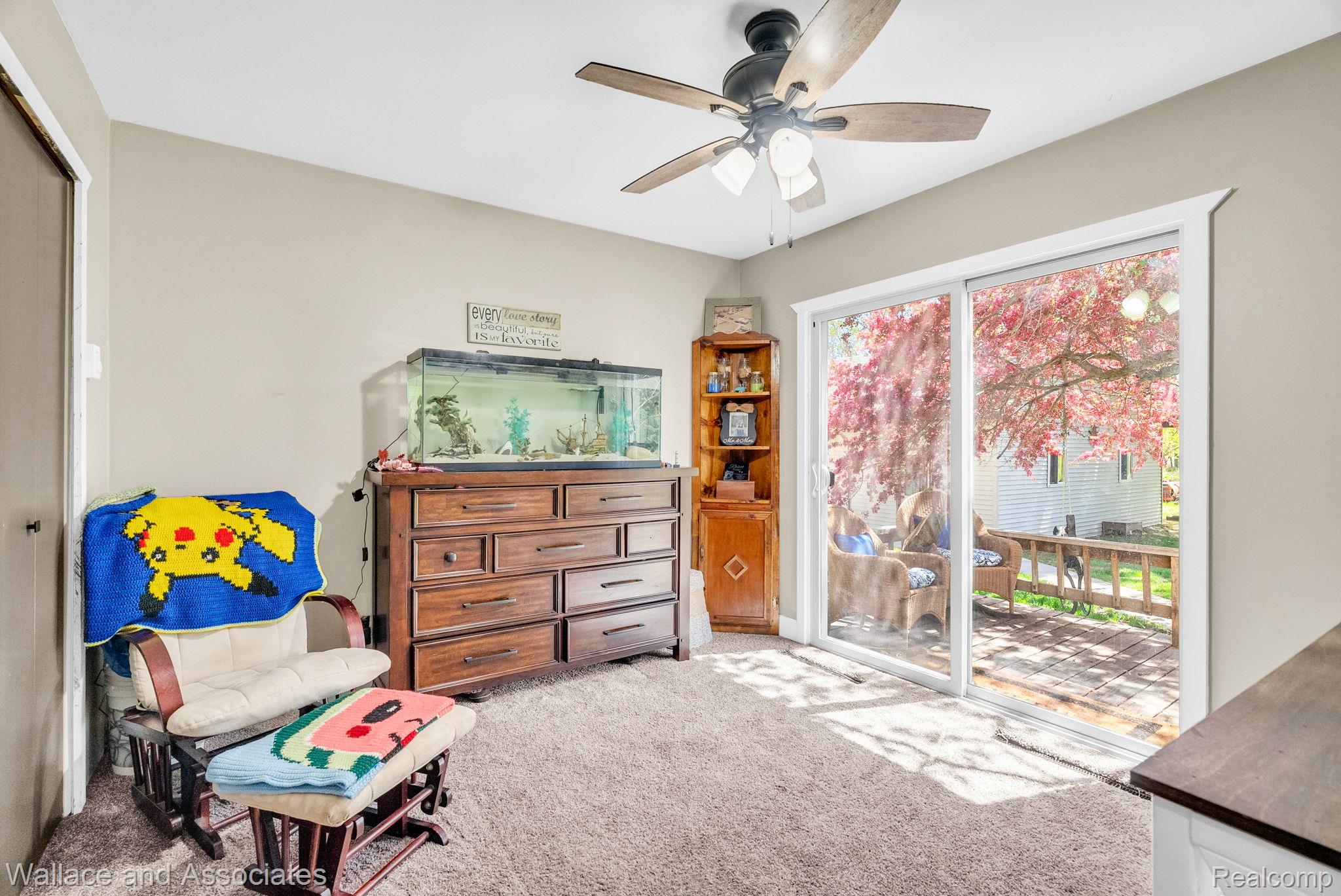 6616 Wellman Line Road Croswell, MI 48422 - Photo 26 of 47 Sitting room with light carpet and ceiling fan