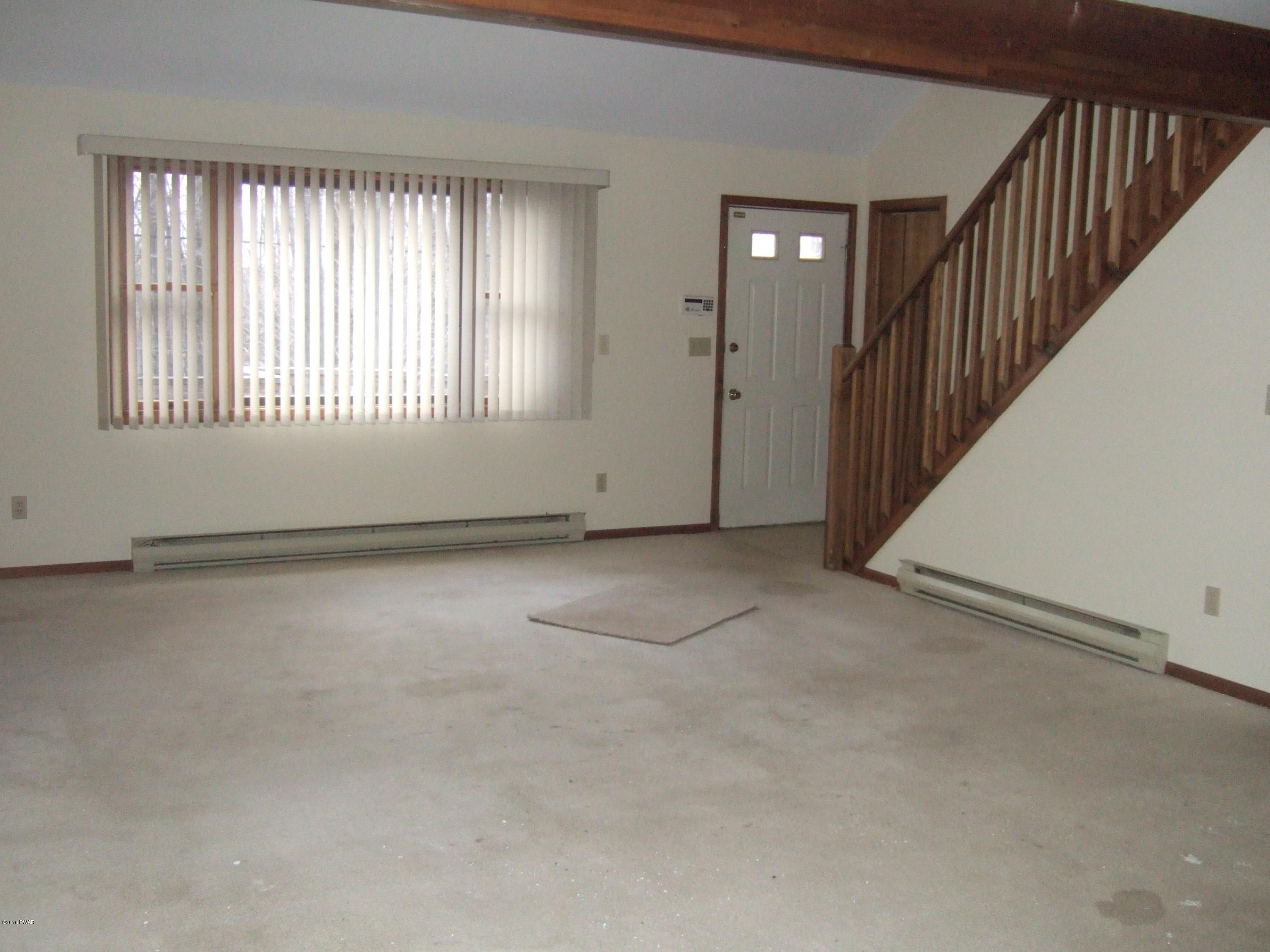 2654 Boulder Road Lake Ariel, PA 18436 - Photo 4 of 40 a view of an empty room with wooden floor and windows
