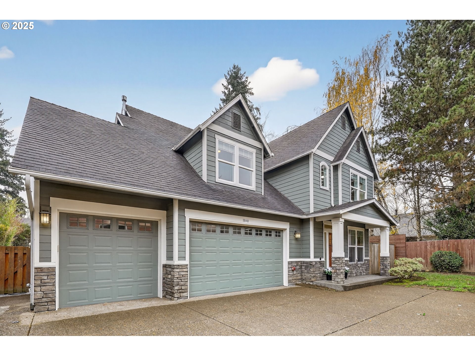 13140 Southwest Madison Court Beaverton, OR 97008 - Photo 1 of 48 a front view of a house with a yard and garage