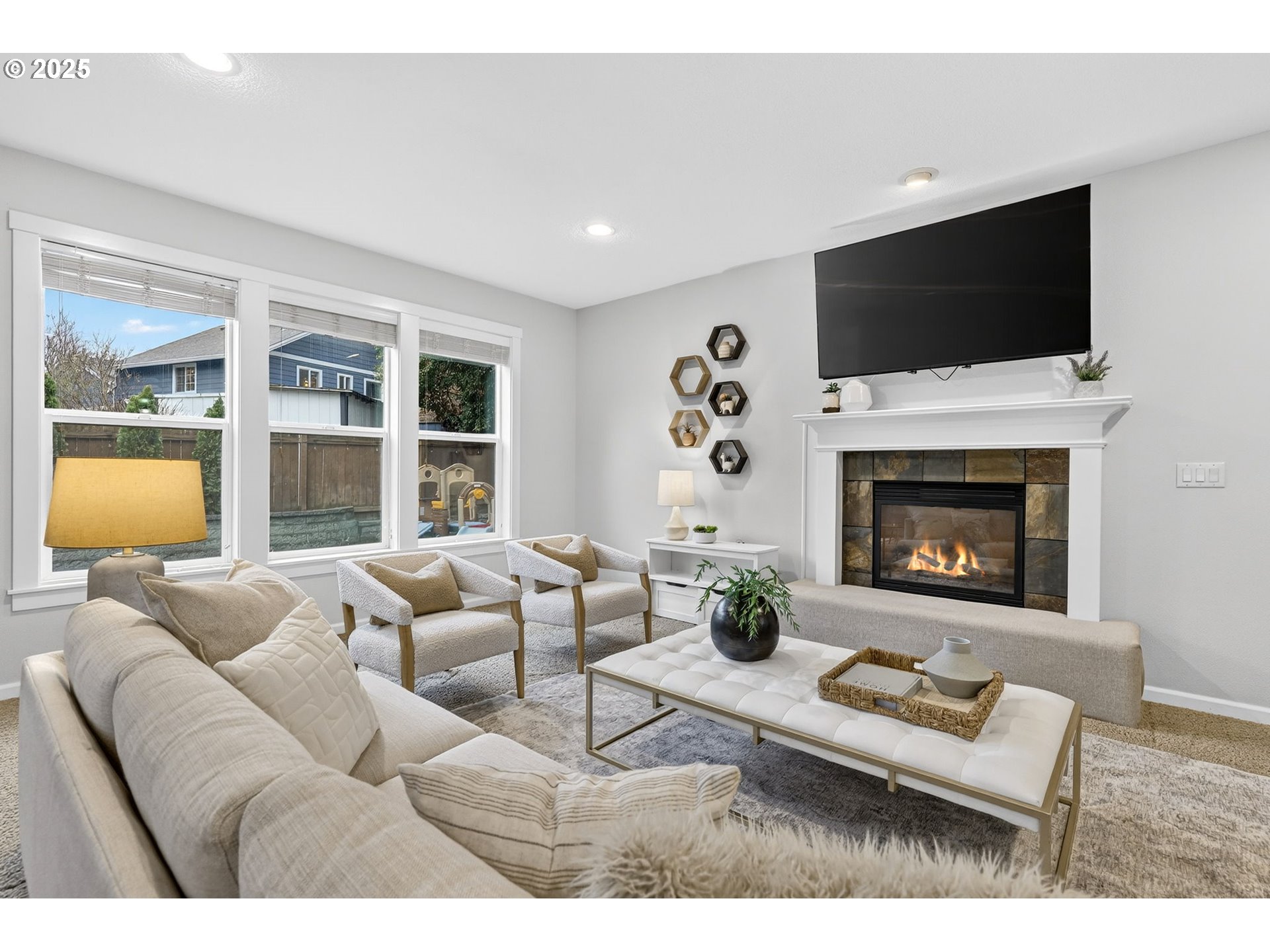 13140 Southwest Madison Court Beaverton, OR 97008 - Photo 11 of 48 a living room with furniture a flat screen tv and a fireplace