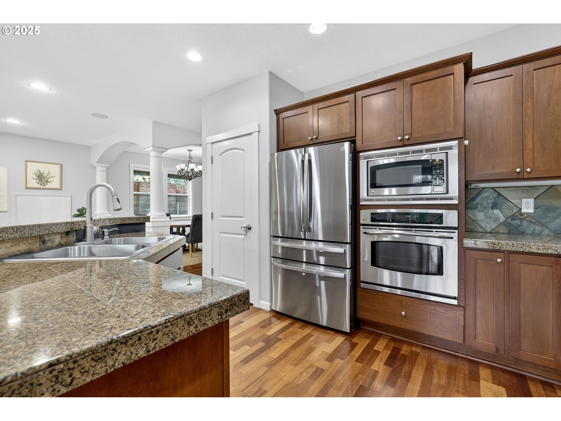 13140 Southwest Madison Court Beaverton, OR 97008 - Photo 17 of 48 a kitchen with granite countertop a refrigerator and a sink