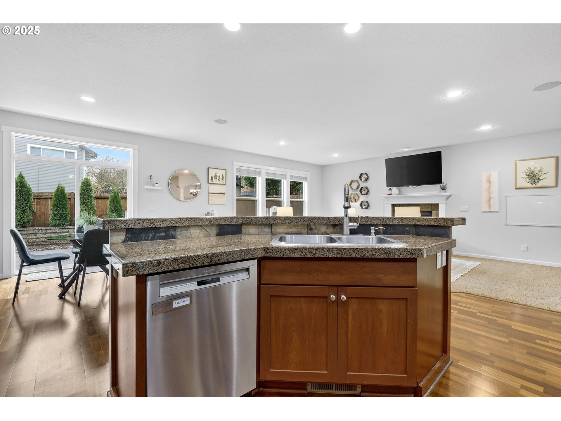 13140 Southwest Madison Court Beaverton, OR 97008 - Photo 18 of 48 a kitchen with granite countertop a stove and a wooden floor