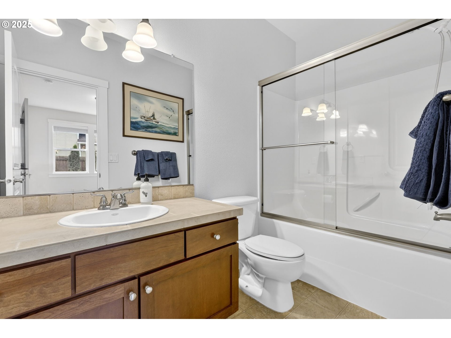 13140 Southwest Madison Court Beaverton, OR 97008 - Photo 22 of 48 a bathroom with a sink a toilet a mirror and shower