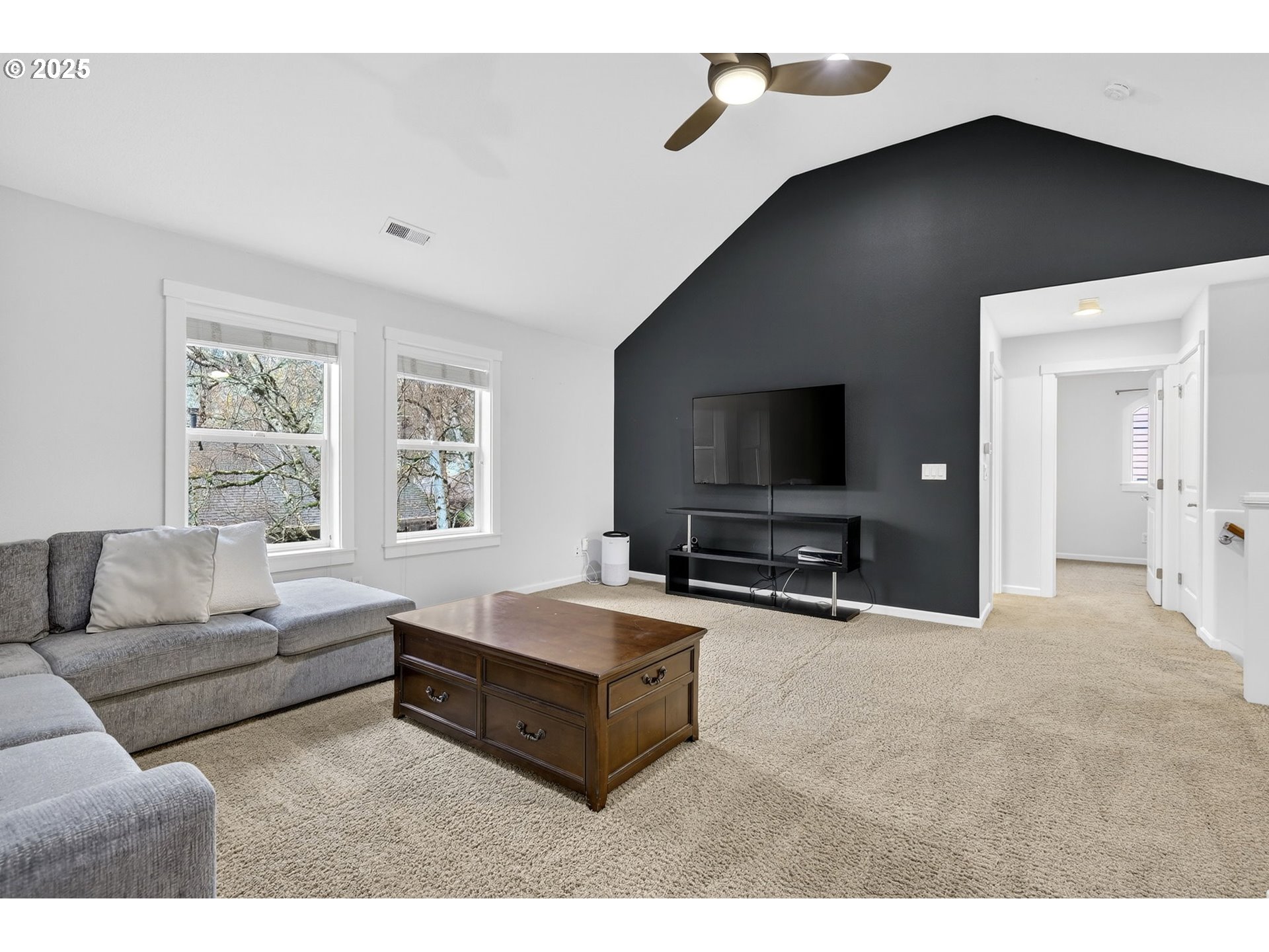 13140 Southwest Madison Court Beaverton, OR 97008 - Photo 24 of 48 a living room with furniture and a flat screen tv