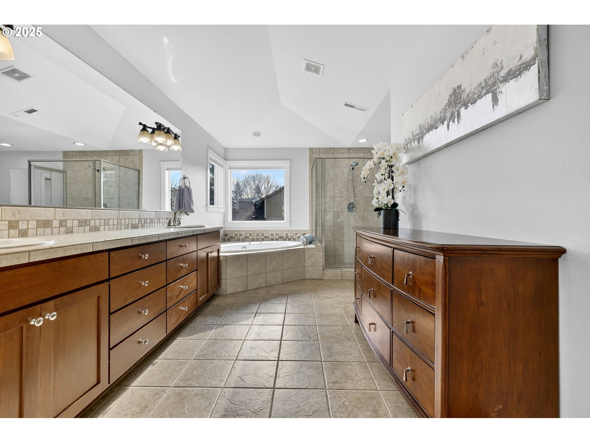 13140 Southwest Madison Court Beaverton, OR 97008 - Photo 29 of 48 a en suite bathroom with a double vanity sink a mirror and a bathtub