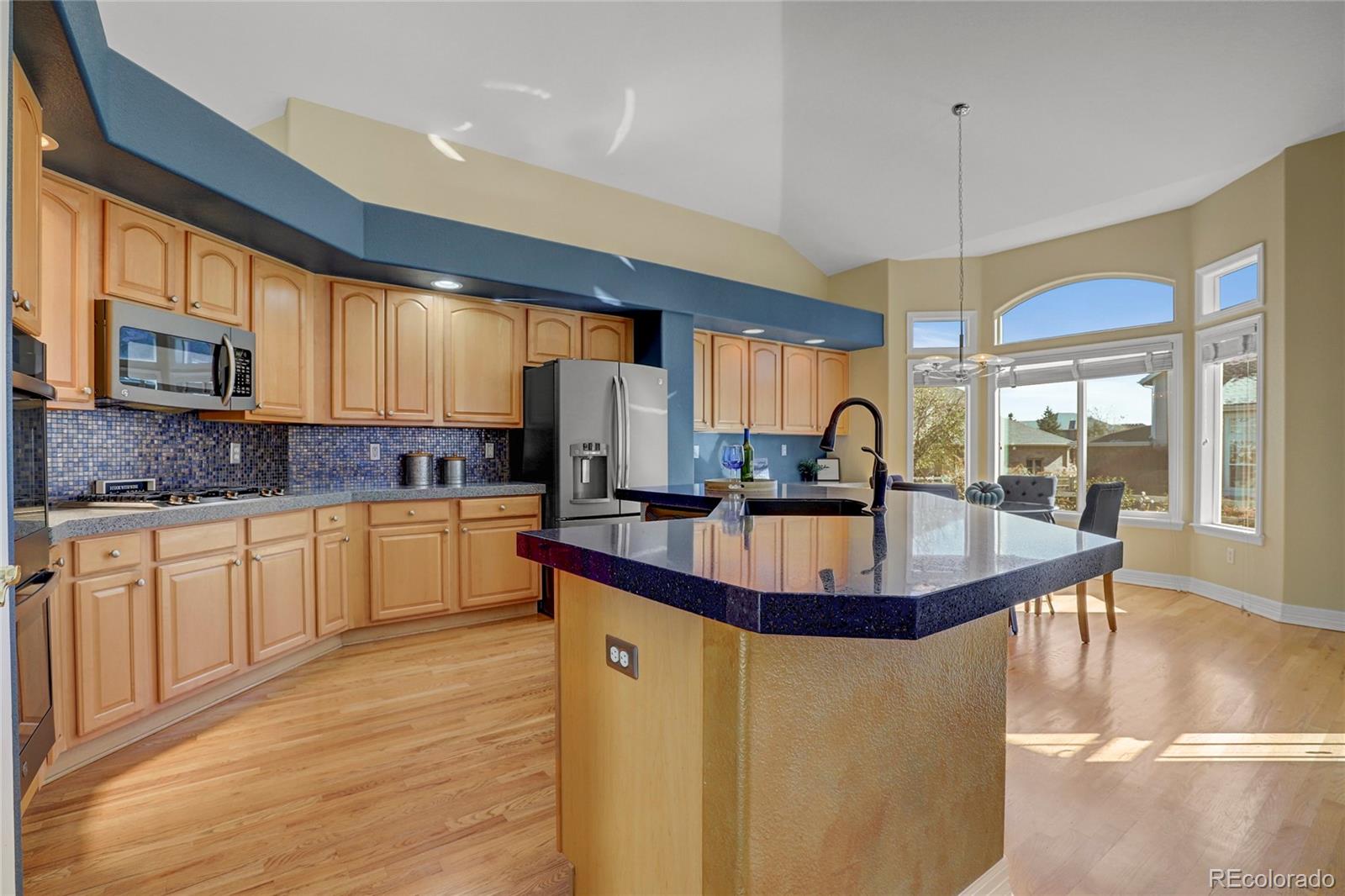 13810 Muirfield Circle Broomfield, CO 80023 - Photo 15 of 45 a kitchen with stainless steel appliances granite countertop a sink a stove and a refrigerator